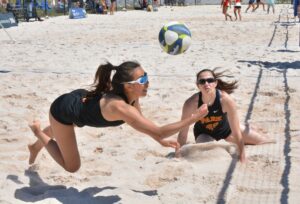 Grecia Ung dives for the ball during the NAIA Women's Beach Volleyball National Invitational Tournament.